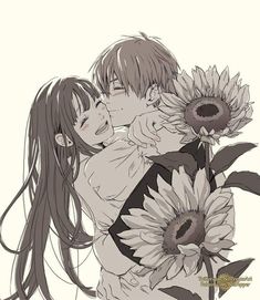 two people hugging each other with sunflowers in front of them