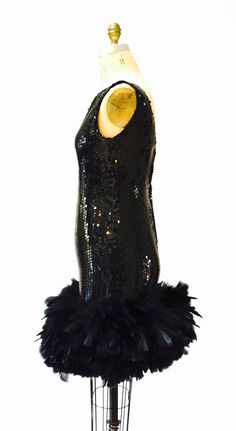 "Breathtaking party dress Black sequins with feathers This lovely features: * Black bodice fully embellished with black sequins * gorgeous super full Feather trim around the hemline * Back zip closure and fully lined * Stunning Dana Deatherage Size Small Synthetic lining Excellent vintage condition Bust 34\" Waist 31\" Hip 37\" Front body length from top of bodice 36\" Visit the shop https://www.etsy.com/shop/Hookedonhoney ** twitter | hookedonhoney ** pinterest | hookedonhoney ** Instagram | ho Black Flapper Sequin Party Dress, Black Flapper Sequin Dress For Party, Glamorous Black Sequined Flapper Dress, Black Cocktail Dresses With Ostrich Feathers, Black Ostrich Feather Cocktail Dress, Fitted Gatsby Sequin Party Dress, Glamorous Evening Flapper Dress With Feathers, Black Ostrich Feather Dress For Night Out, Glamorous Feathered Flapper Dress For Cocktails