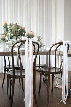 the table is decorated with flowers and ribbons