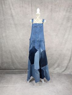 Upcycled denim patchwork overall dress with frayed seams and jagged hem. Adjustable shoulder straps. Flowy, relaxed fit. Waist measures 28" and length is approximately 55". Denim Patchwork Jumpsuit Overalls, Denim Blue Patchwork Cotton Overalls, Denim Blue Patchwork Denim Dress, Dark Wash Denim Patchwork Dress, Dark Wash Denim Dress With Patchwork, Patchwork Sweater, Patchwork Skirt, Knit Infinity Scarf, Poncho Sweater