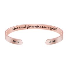 a pink bracelet with an arrow on it that says,'bad heart before mind brave spirit