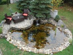 a small pond with some chairs around it