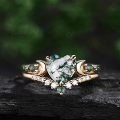 This is a natural moss agate engagement ring in solid gold,about 7mm heart.  The accent stones are pear moss agates and lab emeralds.. The wedding band stones are moissanites and moss agate. The band width is about 1.3-1.4mm. It can be made in any ring size. However please contact me to custom make it to a special big or small size. It can be made in white gold,rose gold or yellow gold with 14k or 18k. However for some people who are nickel allergic,I can also make it to 925 sterling silver to m Three Stone Pear-shaped Jewelry Gift, Pear-shaped Three Stone Jewelry Gift, Pear Moss, Emerald Anniversary, Moss Agate Engagement Ring, Rutilated Quartz Ring, Agate Engagement Ring, Green Moss Agate, Moss Agate Ring