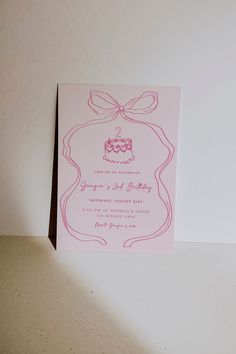 a pink birthday card with a cake on it