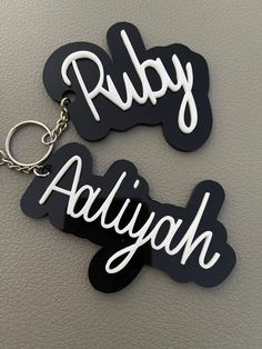 These name keychains are adorable and customized at time of order! Pictures of keychains were made for a cheerleading squad. Base color and name color can be changed to your liking. The font will remain the same. If you would like another font, please check out my other listings or send me a message to see what other fonts are possible.  Please choose base color, name color and ensure that name is spelled as you want it to be. It will be cut as is. Keychain is 4 inches long (outside of the chain part). It will come with key ring/chain to hook onto belongings.  Any other questions or concerns, please feel free to send a message! Thank you for checking out this listing! Customized White Keychains For Everyday Use, Trendy Black Keychains, Black Rectangular Keychain Perfect For Gifts, Rectangular White Keychain For School, Trendy Personalized White Keychains, Black Rectangular Keychain For Gift, Trendy White Personalized Keychains, Personalized White Keychain For School, Customized Rectangular Keychains For School