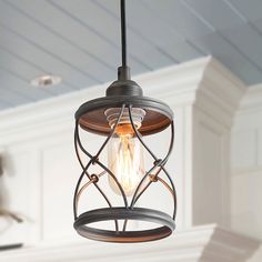 a light fixture hanging from the ceiling in a room with white walls and wood paneling