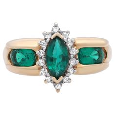 Magnificent ladies cocktail ring. This ring is centered by a beautiful prong set marquise shaped Green Synthetic Emerald. Accentuated with round cut diamonds in a halo setting with oval shaped synthetic emeralds on each side. Mounted in fine 14k yellow gold. Handcrafted masterpiece design. Ring size: 6.5. Total weight: 4.28 grams. Great pre-owned condition. Comes with a presentable gift box. Ladies Ring, Halo Setting, Emerald Diamond, Cocktail Ring, Round Cut Diamond, Cocktail Rings, Prong Setting, Sapphire Ring, Women Rings