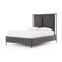 a bed with two headboards and pillows on the top of it, against a white background