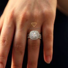 a woman's hand with a diamond ring on top of her finger and an engagement band