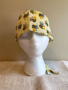 Busy Bees Flannel Standard Scrub Cap. Fits one-size-fits-most, but has adjustable drawstring. Fabric pattern placement varies between caps. Great for Doctors, Nurses, Veterinarians, Vet Techs, and other medical professionals. Made from 100% cotton flannel fabric. Machine washable. Select With Snap Closure to have the cap made with an extra snap added to the back opening to help keep it closed and hair inside the cap. See photos for example. All caps will be made with an adjustable drawstring tie Yellow Cotton Beanie Hat, Adjustable Yellow Cotton Hat, Yellow Adjustable Fitted Cap, Adjustable Fun Style Bonnet Cap, Fun Adjustable Cap-shaped Bonnet, Adjustable Fun Beanie Bonnet, Fun Adjustable Beanie Bonnet, Adjustable Brimmed Cotton Bonnet, Baleen Whales