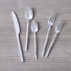 five forks, two spoons and one knife on a wooden table