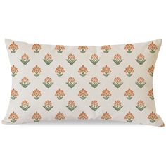 an orange and green floral pillow on a white background