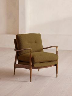 a green chair sitting on top of a hard wood floor