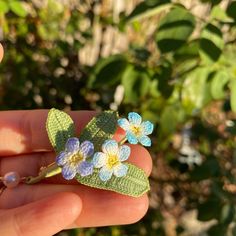 You are checking out a pair of well made earrings using pieces from micro crocheting method. Since they are all handmade. They are one of kind. Length of the flower with stem: Approx. 1.75 inches Individual flower size: Approx. 1/2 x 1/2 inch Individual leaf size: Vary from 0.75 to 1 inch x 1/4 inch Earring material: 14k gold plated  I do have the same style of forget me not flower in earrings form. Please check out this link below: https://www.etsy.com/listing/1487395067/forget-me-not-flower-cr Crochet Brooch, Forget Me Not Flower, Flower Crochet, Blue Crochet, Flower Jewelry, Crochet Flower, Forget Me Not, Summer Accessories, Flower Jewellery