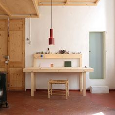 a room with a table, stool and television in it