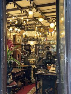 a room filled with lots of different types of furniture and lighting hanging from the ceiling