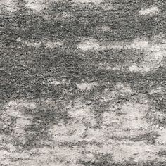 a gray and white rug with small clouds on it's surface in the background