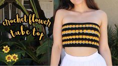 a woman wearing a black and yellow crochet flower tube top with sunflowers in the background