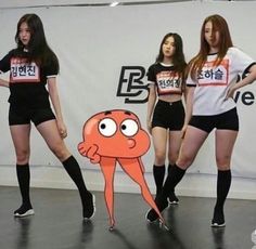 three girls in black shorts and t - shirts with an orange octopus on their chest