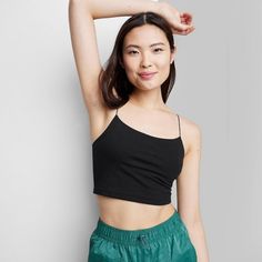 Women's Cropped Cami Tank Top - Wild Fable™ Black M Solid Cropped Camisole With Built-in Bra, Casual Crop Top With Built-in Bra And Medium Support, Spring Cami Sports Bra With Built-in Bra, Casual Solid Crop Top With Built-in Bra, Fitted Camisole Sports Bra For Spring, Casual Camisole Sports Bra With Seamless Construction, Casual Cropped Sports Bra With Built-in Bra, Versatile Crop Top With Tank Straps For Spring, Solid Color Seamless Cropped Camisole