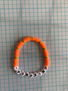 an orange and white beaded bracelet with words on it