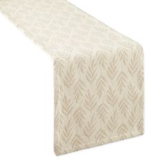 a white table runner with an intricate design