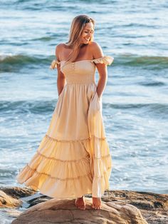 Crafted of lightweight, airy fabric in a flowy silhouette, our Belle maxi dress is the perfect summer staple for every occasion—from a beach vacation to date night or even a girls’ night out. Designed for both comfort and style, the dress features a smocked bodice, strappy back, tassel-tie waist, and of course, pockets. What do we love most about this dress? The flutter sleeves can be worn two ways: off the shoulder or as straps. Convertible flutter sleeves Smocked bodice with buttons Side on-se Flowy Dress Boho, Pineapple Dress, Belle Dress, Flowy Maxi Dress, Dress Crafts, Matching Headband, Boho Maxi, Summer Staples, Dress Purchase