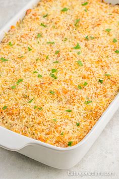 a casserole dish with cheese and parmesan sprinkled on top