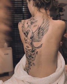 a woman with a bird tattoo on her back