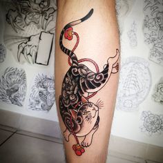 a cat and mouse tattoo on the leg