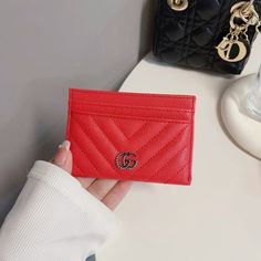 Introducing the epitome of sophistication and style: the Classic GG Wallet Card Holder - Luxury Edition. Crafted with meticulous attention to detail and unparalleled craftsmanship, this accessory seamlessly merges timeless elegance with modern functionality. Made from the finest quality materials, the Classic GG Wallet exudes luxury at every touch. Its iconic GG monogram pattern embossed on premium leather not only showcases impeccable taste but also speaks volumes about your discerning eye for Luxury Classic Wallet With Interior Card Slots, Luxury Designer Trifold Wallet With Interior Card Slots, Luxury Classic Red Card Holder, Elegant Red Leather Card Holder, Elegant Red Wallet With Rfid Blocking, Elegant Red Wallet With Interior Card Slots, Elegant Red Wallet For Business, Elegant Red Wallets For Business, Trendy Rectangular Formal Wallets