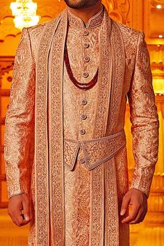 Rust sherwani with all-over self-embroidered motifs. Comes with kamarbandh, dupatta and churidar.
Components:4
Embroidered
Neckline:Mandarin Collar
Sleeve Length: Full
Fabric: Silk
Color:Peach, Orange


Closure: Front buttons - Aza Fashions Orange Zari Work Sherwani For Wedding, Orange Sherwani With Zari Work For Wedding, Orange Wedding Sherwani With Zari Work, Wedding Orange Sherwani With Zari Work, Peach Traditional Wear With Traditional Drape, Orange Sherwani For Wedding Eid Festival, Orange Sherwani For Wedding And Eid, Orange Sherwani For Wedding At Eid, Traditional Peach Kurta With Traditional Drape