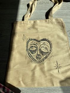 a tote bag with an image of a face on it