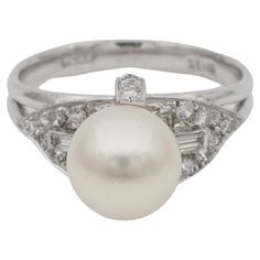 Her Majestic the Pearl Elegantly designed and crafted is this beautiful mid century Pearl Solitaire ring complemented by Diamonds post 1960 ca, hand crafted of solid Platinum marked Articulate in design showing geometric shoulders and sinuous up front lines both complemented by fine quality Diamonds supporting the main Pearl mounted as solitaire Pearl is a perfectly round salt water origin 8.1 mm. AAA quality perfect lustre and skin thick nacre and silky sheen subtle white cream colour Diamonds Modernist Diamond Ring For Formal Occasions, Modernist Oval Jewelry For Formal Occasions, Modern Multi-stone Diamond Ring For Wedding, Modernist White Gold Diamond Jewelry, Vintage Tension Setting Ring Jewelry, Vintage Diamond Ring With Tension Setting, Vintage White Gold Multi-stone Ring, Art Deco Multi-stone Ring For Formal Occasions, Modernist Oval Rings For Formal Events