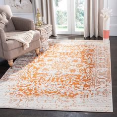 an orange and white area rug in a living room with two chairs, one chair and the