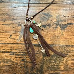 Handmade in Idaho by Weathered Soul exclusively for Bourbon Cowgirl. Limited Edition, high quality jewelry that is as unique and authentic as you! Due to their handcrafted nature, slight variations will occur. The feel and design of the product will remain true to the overall aesthetic. Features the following materials: Jewelers Pewter Copper Turquoise Deer Leather Made exclusively for us by Weathered Soul Brown Spiritual Dangle Jewelry, Artisan Silver Lariat Necklace For Gift, Silver Artisan Lariat Necklace For Gift, Artisan Handmade Silver Lariat Necklace, Handmade Artisan Silver Lariat Necklace, Artisan Dangle Charms Jewelry, Lariat Jewelry Charms As A Gift, Lariat Charms Jewelry Gift, Artisan Necklace With Charms And Round Pendant