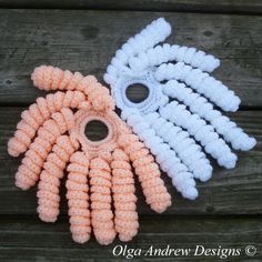 three crocheted objects sitting on top of a wooden table