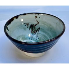 a blue and white bowl sitting on top of a table