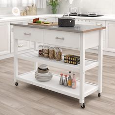 a kitchen island cart with food on it in the middle of a white and wood floored kitchen