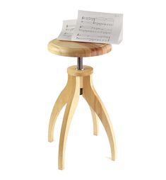 a wooden stool with sheet music on it