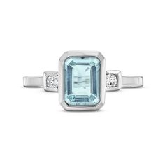 This Aquamarine Diamond Bezel Ring features an emerald cut aquamarine weighing approimately 1.60 carats accented with 0.08 carats of round brilliant cut diamonds on each side. Emerald Cut Aquamarine Rings With Gemstone Accents, Blue Topaz Emerald Cut Ring With Bezel Setting, Emerald Cut Blue Topaz Ring With Bezel Setting, Emerald Cut Light Blue Topaz Ring With Accent Stones, Light Blue Emerald-cut Topaz Ring With Accent Stones, Light Blue Emerald Cut Topaz Ring With Accent Stones, Octagon Aquamarine Ring With Accent Stones, Octagon Aquamarine Rings With Accent Stones, Aquamarine Rings With Accent Stones In Octagon Shape