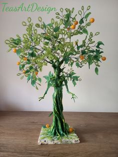 an orange tree with green leaves and branches