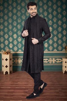 Introducing our exquisite Mens Sherwani- V2-S043, a sophisticated addition to your wardrobe. This luxurious black sherwani features intricate cutdana and zardozi embroidery, elevating its elegant design. It also includes a matching dupatta. This sherwani exudes exclusivity and refinement. Indulge in a timeless piece of art, with our Mens Sherwani-V2-S043. Black Sherwani With Chikankari Embroidery, Black Fitted Sherwani For Designer Wear, Festive Black Bandhgala With Chikankari Embroidery, Black Chikankari Embroidered Sherwani, Black Fitted Designer Sherwani, Black Chikankari Embroidery Sherwani, Black Long Sleeve Bandhgala With Chikankari Embroidery, Designer Black Nehru Jacket With Traditional Drape, Designer Black Kurta With Intricate Embroidery