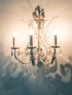 a crystal chandelier with two candles on it