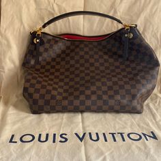 Almost Brand New Louis Vuitton Bag. Similar In Style To The "Graceful Pm", Can't Remember The Exact Name. Only Used A Few Times, Non Smoker. Damier Ebene Pattern. Gold Colored Hardware. Zipper Top. Red Lining. Cell Phone Pocket And Key Ring. About 18 Inches Wide. 12 Inches Tall. Opening 12 Inches Wide. Bottom To Top Of Handle 19 Inches. Comes With Dust Cover Bag. Louis Vuitton Hobo Bag, Louis Vuitton Hobo, Louis Vuitton Metis, Louis Vuitton Mm, Louis Vuitton Delightful, Louis Vuitton Artsy Mm, Louis Vuitton Artsy, Louis Vuitton Purse, Louis Vuitton Damier Ebene