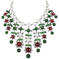 This very early Chanel Gripoix and Pearl Bib Necklace is in excellent vintage condition. It is a one of a kind highly collectible piece designed by Coco herself from the Diana Vreeland estate sale. Faux pearl choker with red and green dripping Gripoix stones and crystals. Extremely rare. Measures approximatley 17inches. Vintage Chanel Jewelry, Pearl Bib Necklace, Buy Earrings Online, Necklaces Choker, Vintage Choker Necklace, Unique Fashion Jewelry, Diana Vreeland, Vintage Choker, Gems Bracelet