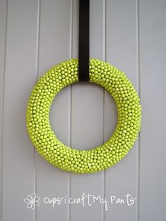 a yellow beaded wreath hanging on the front door