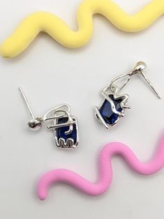 These abstract blue spinel drop earrings are truly one of a kind. Inspired by the 1980s Memphis Milano design group, they feature squiggly sterling silver lines that dance on top of the stones. Made from scratch, these blue spinels are the perfect gift for an art lover!  🔨🔨 Process 🔨🔨 These earrings were lovingly handmade using the lost wax casting process. I used various waxes to create the squiggly shapes around the stones. The wax models were then sent to a caster here in Australia where Trendy Blue Sterling Silver Earrings, Memphis Milano Design, Memphis Milano, Blue Spinel, Spinel Gemstone, Memphis Design, Wax Casting, Lost Wax Casting, Silver Line