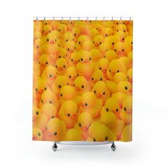 a shower curtain with many yellow rubber ducks in the middle, all looking different directions