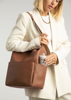 Stevie Midi is gender-neutral, edgy, and has the space to hold just the essentials. From a hike to the store, from work to the park, her eight internal pockets and easy-to-clean microfiber vegan leather make her the perfect bag to take just about anywhere. This ‘just right size’ is ideal for the mama who’s ready to downsize, and who likes nice things yet doesn’t want to fear the rough & tumble. Stevie’s all about options – her backpack converts to a shoulder strap, and her intuitive internal org Stroller Hooks, Matte Black Hardware, Clean Microfiber, Backpack Straps, Nice Things, Black Hardware, Perfect Bag, The Space, Laptop Sleeves